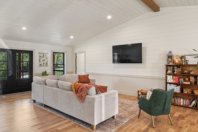 living room featuring french doors, light hardwood / wood-style floors, lofted ceiling with beams, and wood ceiling