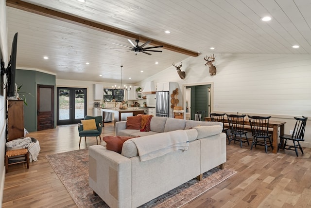 living room with vaulted ceiling with beams, french doors, wood ceiling, and light hardwood / wood-style floors