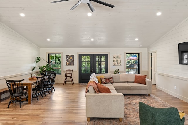 living room featuring vaulted ceiling, ceiling fan, light hardwood / wood-style floors, and plenty of natural light