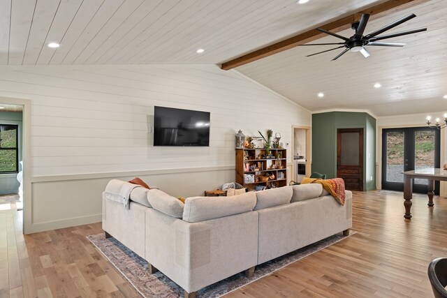 living room featuring wooden ceiling, vaulted ceiling with beams, light hardwood / wood-style flooring, ceiling fan with notable chandelier, and french doors