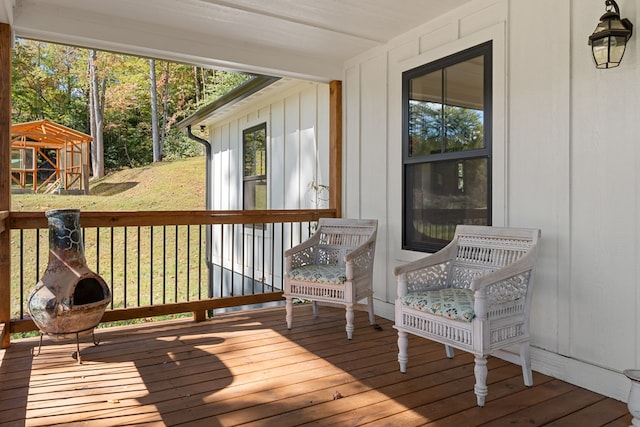 wooden terrace with a yard and a gazebo