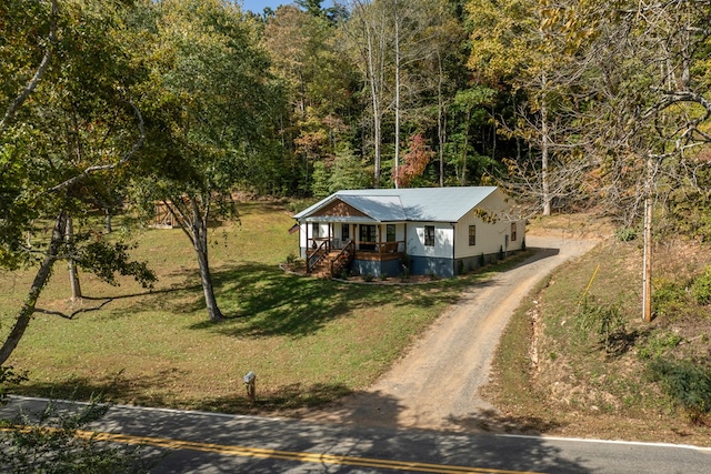 view of front of property with covered porch and a front lawn