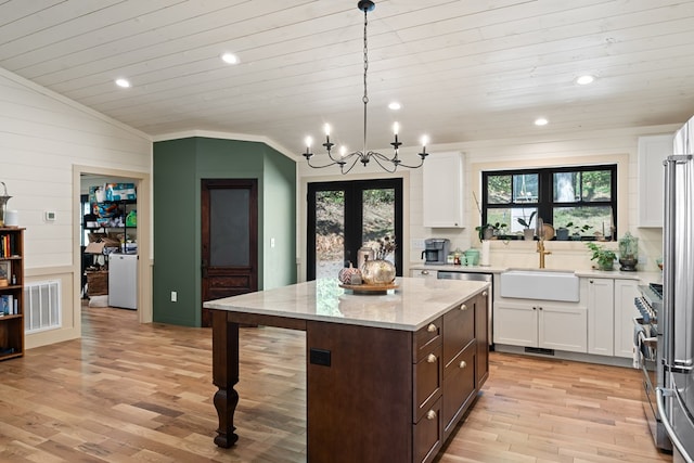 kitchen with sink, light hardwood / wood-style floors, and vaulted ceiling