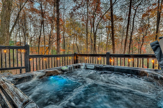 wooden deck with a hot tub