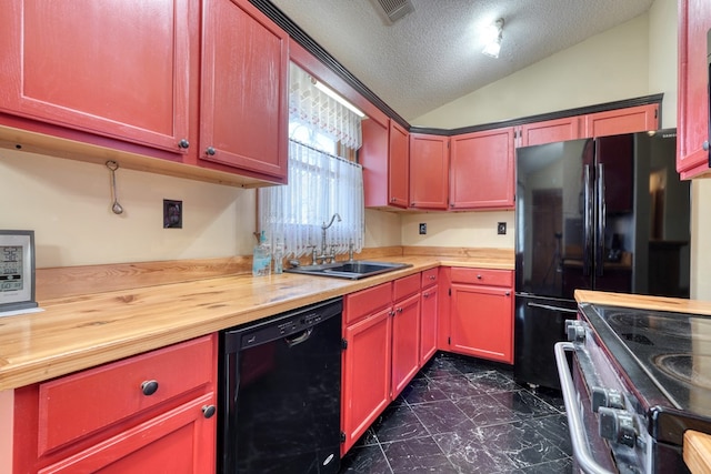 kitchen with wooden counters, vaulted ceiling, sink, and black appliances