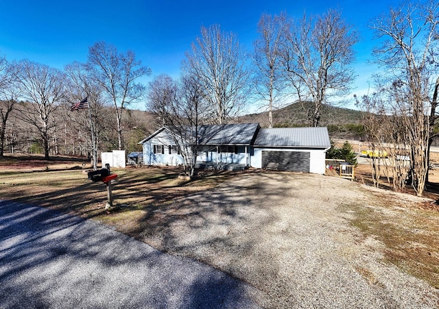 view of front of property featuring a mountain view and a garage