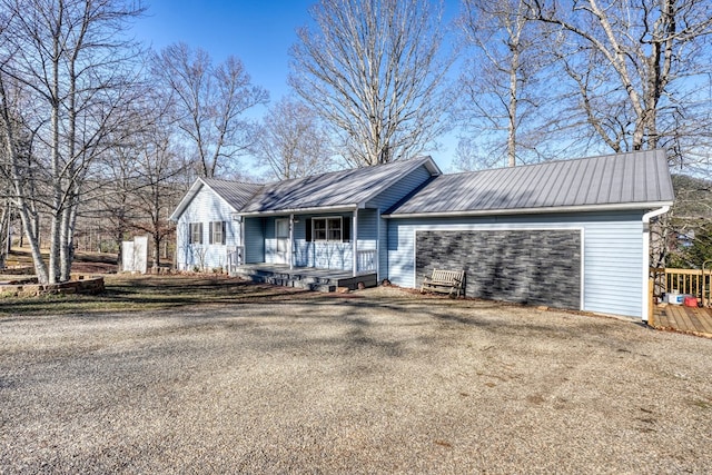 ranch-style home with a porch and a garage