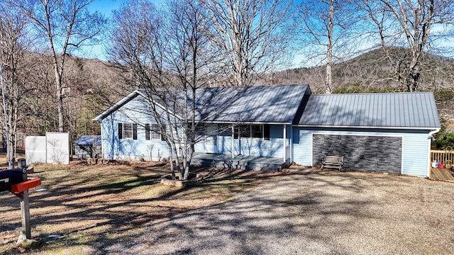 single story home featuring a garage and a mountain view