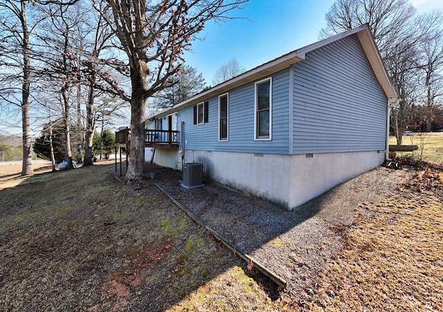 view of property exterior with central air condition unit and a wooden deck