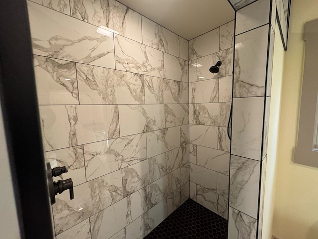 bathroom with a tile shower