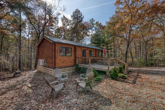 back of house featuring a wooden deck and ac unit