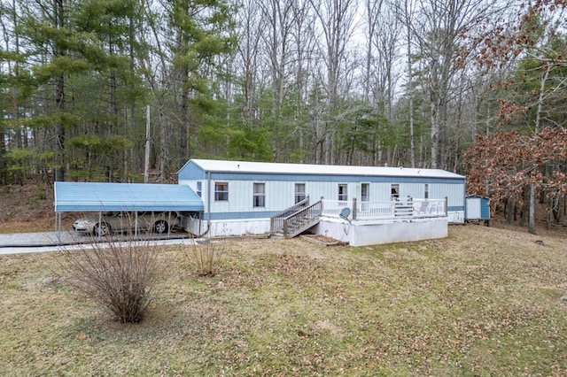 view of front facade with a carport and a front yard