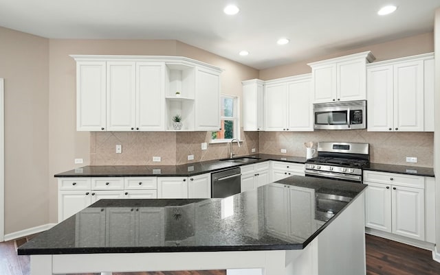 6665 Flagstone Ct, Cumming, GA 30028 - kitchen with appliances with stainless steel finishes, open shelves, dark wood-style flooring, white cabinetry, and recessed lighting