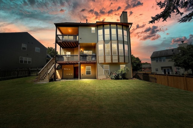 6665 Flagstone Ct, Cumming, GA 30028 - back of house at dusk featuring a balcony, a fenced backyard, stairway, a chimney, and an attached garage