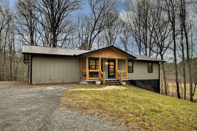 single story home featuring a front lawn and covered porch