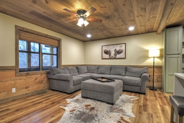 living room with wood walls, light hardwood / wood-style floors, and wooden ceiling