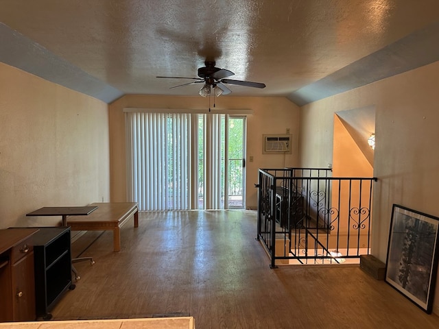 hallway featuring a textured ceiling, lofted ceiling, and hardwood / wood-style flooring