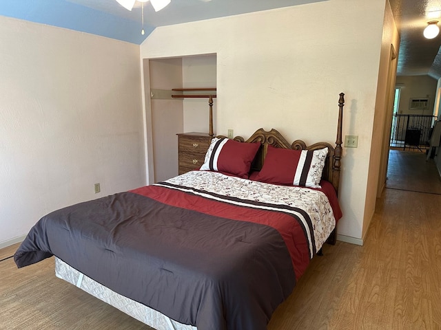 bedroom featuring vaulted ceiling and hardwood / wood-style floors