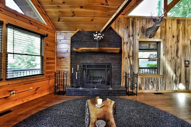 162 Grayson Pt, Blue Ridge, GA 30513 - living room featuring wooden ceiling, wooden walls, wood finished floors, and a stone fireplace