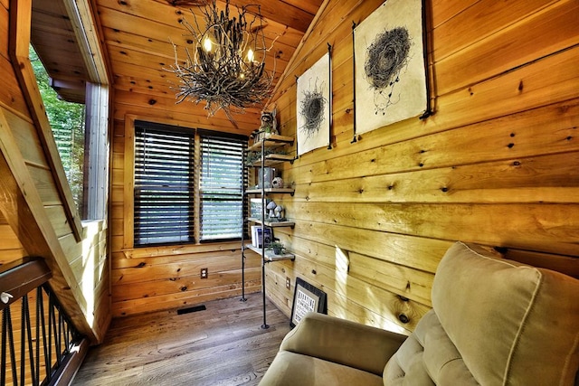162 Grayson Pt, Blue Ridge, GA 30513 - living area with wood walls, a chandelier, vaulted ceiling, and wood finished floors