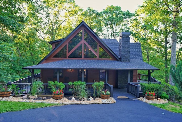 162 Grayson Pt, Blue Ridge, GA 30513 - view of front facade featuring covered porch, roof with shingles, a chimney, and stone siding