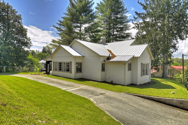 102 Riverview St, Copperhill, TN 37317 - back of house with fence, a standing seam roof, metal roof, a lawn, and driveway