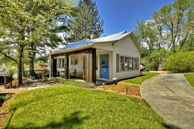 102 Riverview St, Copperhill, TN 37317 - back of property featuring a yard, metal roof, and a chimney