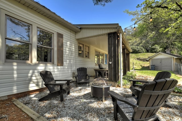 102 Riverview St, Copperhill, TN 37317 - view of patio featuring an outdoor structure, a fire pit, and a shed