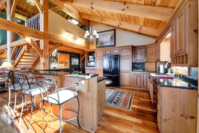 kitchen with backsplash, high vaulted ceiling, an inviting chandelier, black appliances, and wood ceiling