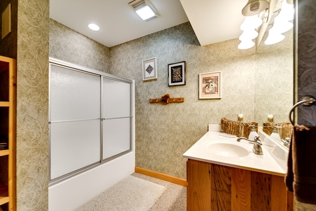 bathroom with shower / bath combination with glass door and vanity