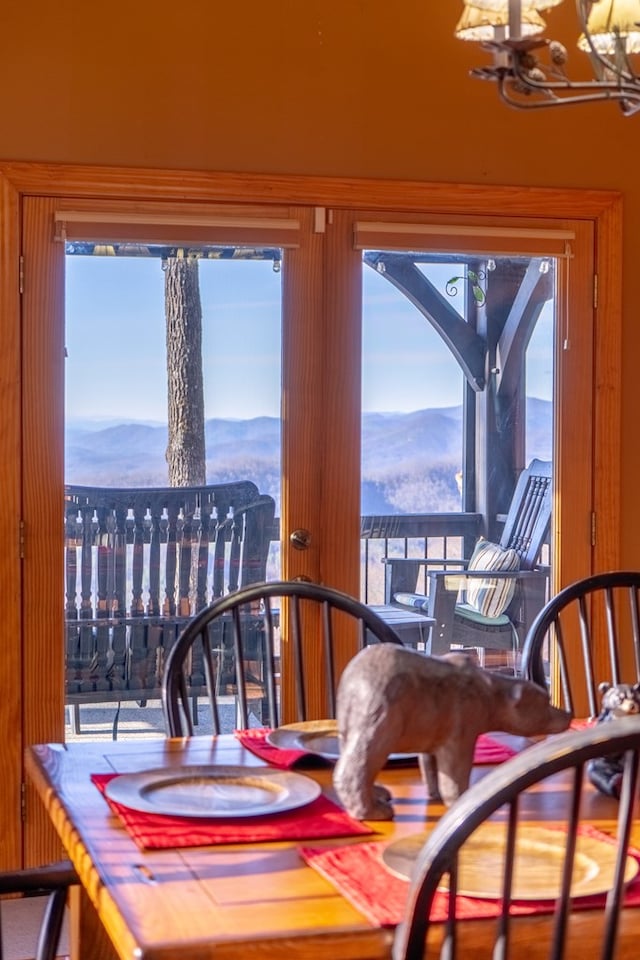 dining space featuring a mountain view and an inviting chandelier