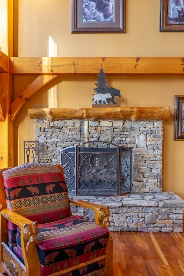 living area with wood-type flooring and a fireplace