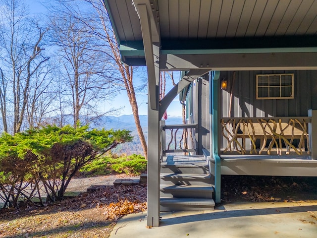 deck featuring a mountain view and a porch