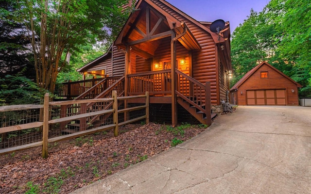 log cabin with a garage and an outdoor structure