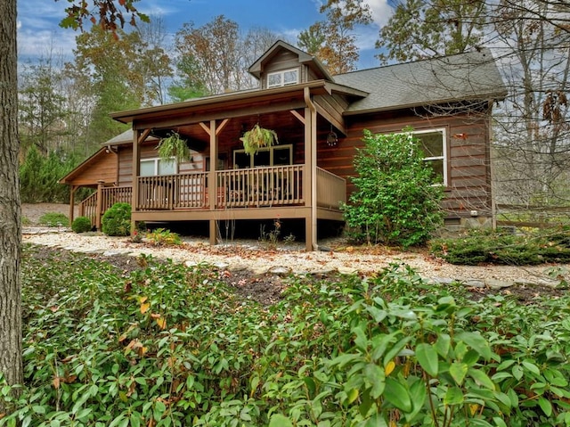 view of front of home featuring a shingled roof and crawl space