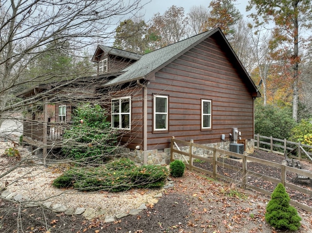 view of home's exterior featuring crawl space and fence