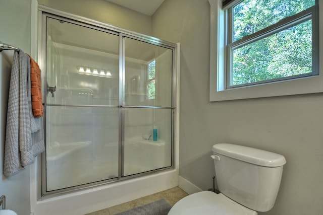 full bath featuring baseboards, toilet, and an enclosed shower