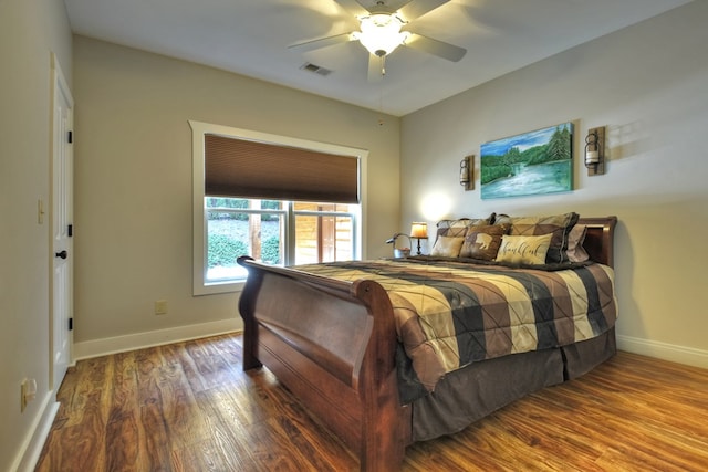 bedroom with visible vents, ceiling fan, baseboards, and wood finished floors