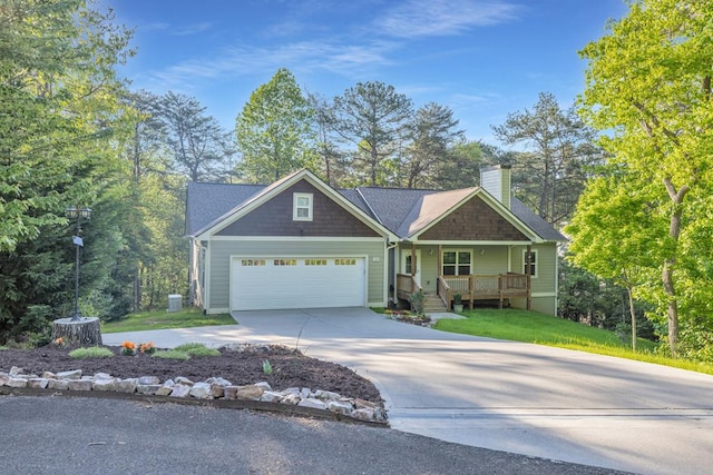 craftsman-style house featuring a chimney, a garage, covered porch, and driveway