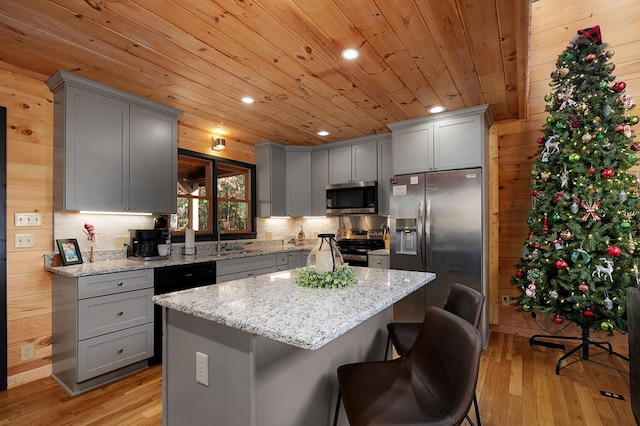 327 Dancing Trees Trl, Morganton, GA 30560 - kitchen featuring appliances with stainless steel finishes, gray cabinets, light wood-style floors, wooden ceiling, and wood walls