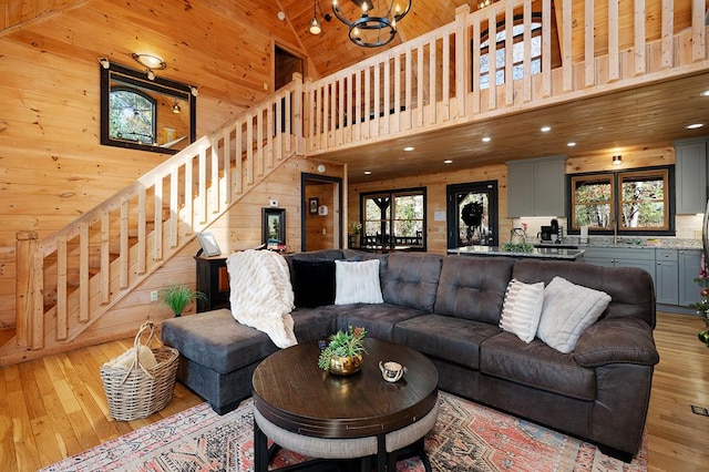 327 Dancing Trees Trl, Morganton, GA 30560 - living room with wood walls, stairway, light wood-style flooring, a towering ceiling, and recessed lighting