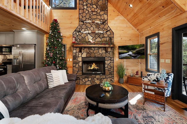 327 Dancing Trees Trl, Morganton, GA 30560 - living room with wooden ceiling, wood finished floors, high vaulted ceiling, a stone fireplace, and wooden walls