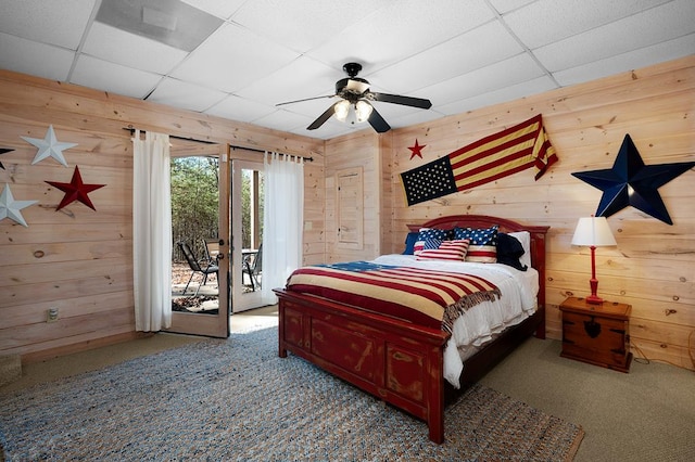 327 Dancing Trees Trl, Morganton, GA 30560 - carpeted bedroom with wood walls, access to exterior, ceiling fan, and a drop ceiling