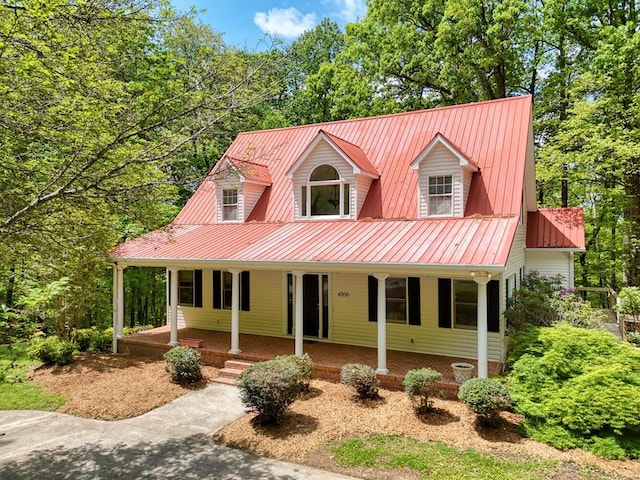 view of front facade with a porch and metal roof