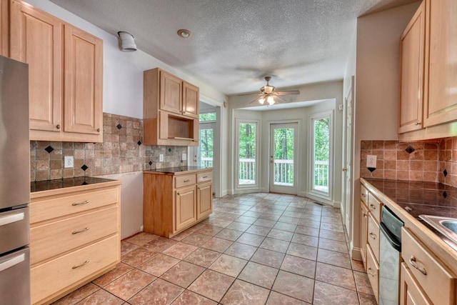 kitchen with light brown cabinetry, ceiling fan, a textured ceiling, stainless steel appliances, and backsplash