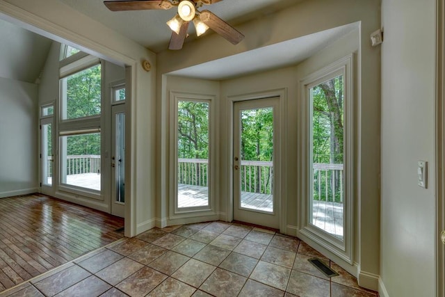 entryway featuring baseboards, ceiling fan, visible vents, and a healthy amount of sunlight