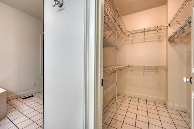 walk in closet featuring visible vents and light tile patterned floors