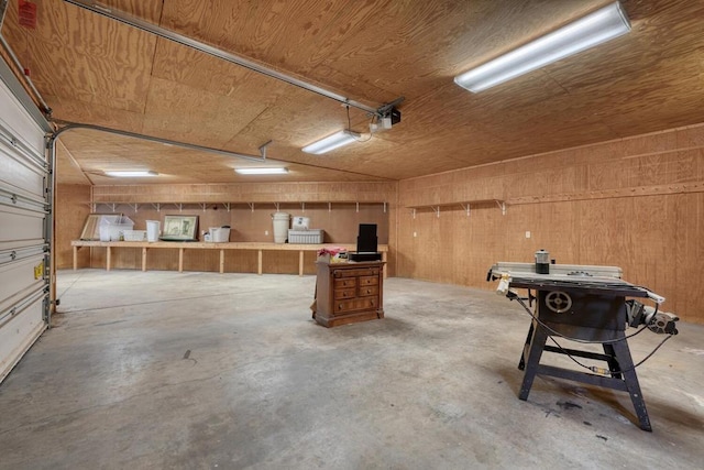 garage with a garage door opener and wooden walls