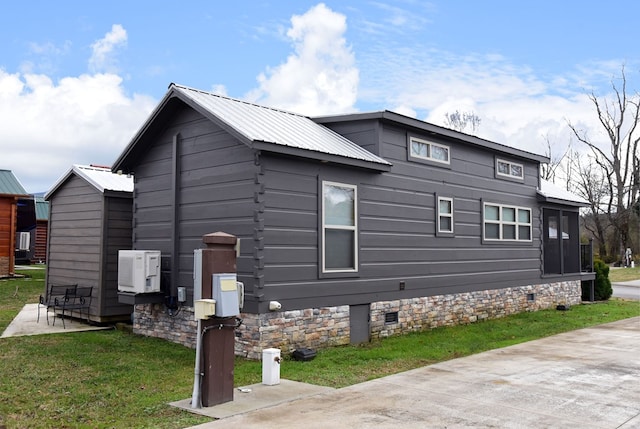 view of side of home with crawl space, a patio area, metal roof, and a lawn