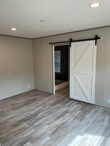 755 Orchard, Ellijay, GA 30540 - empty room with wood finished floors, recessed lighting, and a barn door